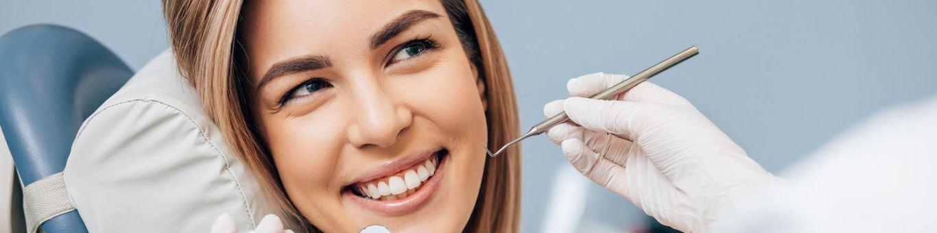 Young smiling woman getting a dental examination.