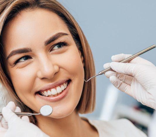 Young smiling woman getting a dental examination.