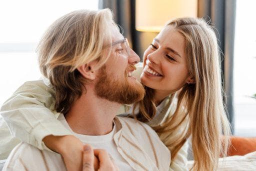 Woman and man smiling at each other.