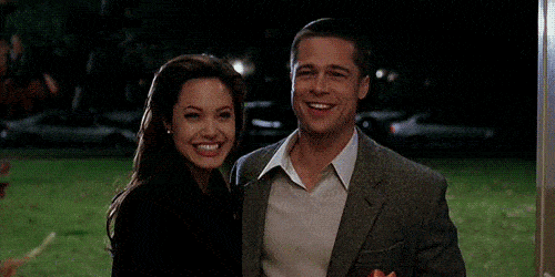 Angelina Jolie and Brad Pitt smiling.
