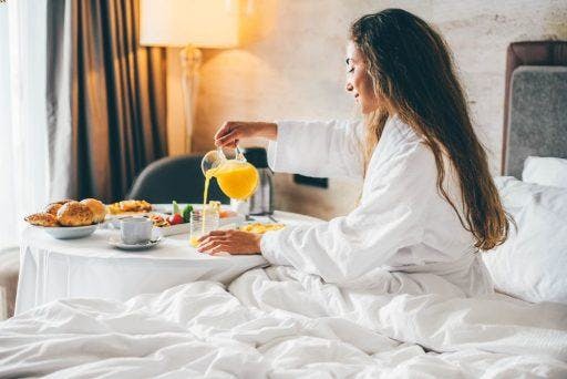 Woman having breakfast in bed.